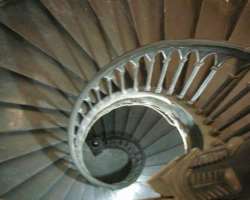 The church has a beautiful building with a circula The church has a beautiful building with a circular layout made with grey marble tiles. Its door also attracts visitors made up of solid teak with bra